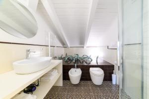 a bathroom with a sink and a toilet at Zia Pupetta Suites in Amalfi +58 photos