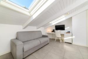 a living room with a couch and a desk at Zia Pupetta Suites in Amalfi