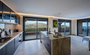 a large kitchen with a view of the ocean at Palacio de Cantalobos in Almuñécar