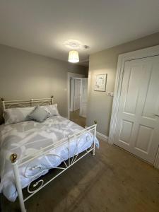 a bedroom with a bed and a white door at Riverside Cottage in Kildare