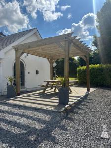 a wooden picnic table in front of a building at Riverside Cottage in Kildare