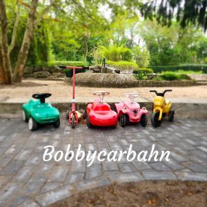 a group of toy cars sitting on a patio at Ferienwohnungen Margaretenhof am Plauer See in Brandenburg an der Havel +108 photos