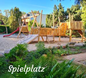a playground with a slide and a swing set at Ferienwohnungen Margaretenhof am Plauer See in Brandenburg an der Havel