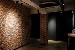 a brick wall with a heart painted on it at Original Backpackers in Seoul