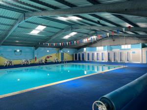 a large swimming pool in a large building at Hectors, Two bed Chalet on Sunbeach Holiday Park - Sleeps 4, pet friendly - plus WiFi, bed linen and towels included only 300m from the beach! in Great Yarmouth