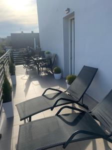 a balcony with chairs and a laptop computer on it at AgA in Pobierowo