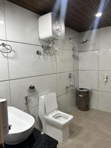 a bathroom with a toilet and a sink at Willow Winds Home Stay in Theog