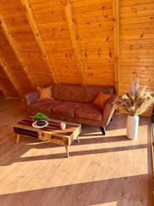 a living room with a couch and a coffee table at Harmony Cottage - Private Jacuzzi & Nature in Banja Luka