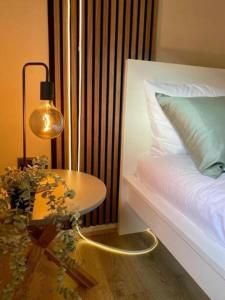 a bedroom with a bed with a table and a lamp at 1BR Haven in Crewe - Modern, Chic & Central in Crewe