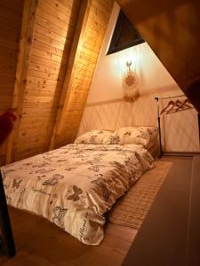 a bedroom with a bed in a attic at Harmony Cottage - Private Jacuzzi & Nature in Banja Luka