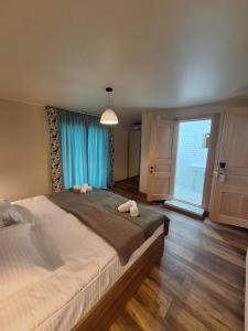 a bedroom with a large bed and a large window at Hotel-restaurant Stumari in Ushguli +9 photos