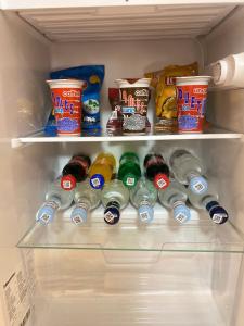 a refrigerator filled with lots of water bottles and food at Elite Guesthouse in Pʼarakʼar +18 photos