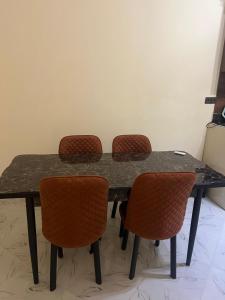 a black table with four chairs around it at Résidence Atlantic in Agadir