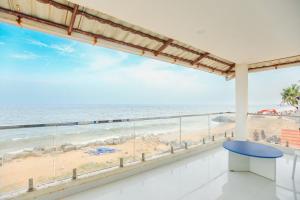a view of the beach from the balcony of a beach house at CASA Lasa Beach view in Kālapettai
