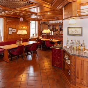 a restaurant with wooden ceilings and tables and chairs at Hotel Jesteburger Hof in Jesteburg
