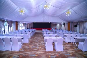 a banquet hall with white tables and white chairs at Best Western Dodoma City Hotel in Dodoma +245 photos