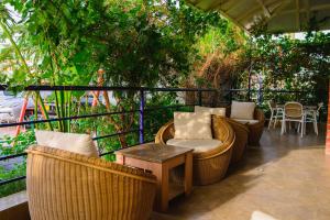 a patio with wicker chairs and tables on a balcony at Best Western Dodoma City Hotel in Dodoma