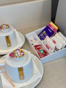 a table with two plates and a tray of food at The Originals Boutique, Hôtel Cassitel, Cassis in Cassis +32 photos