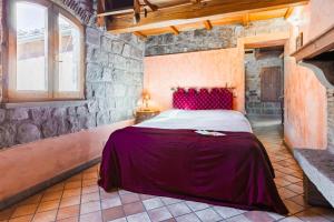 a bedroom with a bed in a stone wall at Parco del Paradosso in Viterbo