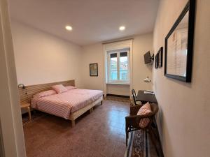 a small bedroom with a bed and a window at CASABONA1910 bed&breakfast in Vercelli
