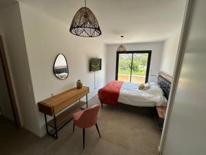 a bedroom with a bed and a desk and a mirror at Villa Corail- Piscine privée- Corsu di Core in Conca +15 photos