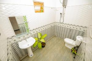 a bathroom with a sink and a toilet at Enu Homestay in Dickwella +25 photos