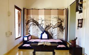 a room with a bed with a painting on the wall at Bukchondaek in Andong