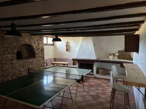 a living room with a table and chairs and a fireplace at masia riu dels arbres in Benasal