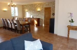 a dining room and living room with a table and chairs at La Vergne in Saint-Martin-des-Combes