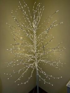 a christmas tree with lights on a wall at Casa nella Corte in Bellano