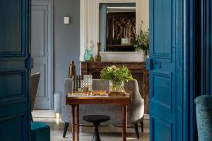 a room with a table and chairs and a fireplace at Château Saint Gilles - Bayeux in Guéron +90 photos