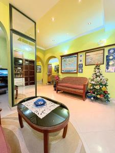 a living room with a couch and a christmas tree at Garni Hotel Bokeška Noć in Herceg-Novi