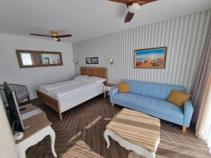 a living room with a bed and a couch at Ocean View Apartments in Lourinhã +33 photos