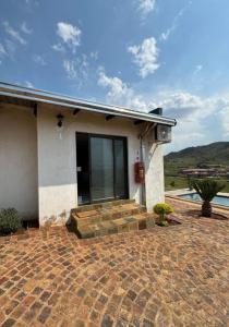 a house with a patio and a swimming pool at JandJ Guest House in Armburg