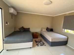 a bedroom with two beds in a room at JandJ Guest House in Armburg