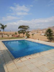 a swimming pool with blue water in a yard at JandJ Guest House in Armburg