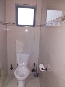 a bathroom with a white toilet and a window at JandJ Guest House in Armburg +20 photos