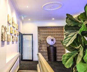 a room with a staircase with a plant and a ceiling at Plantation Hotel Coffs Harbour in Coffs Harbour +16 photos