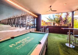 a pool table in a restaurant with a bar at Plantation Hotel Coffs Harbour in Coffs Harbour