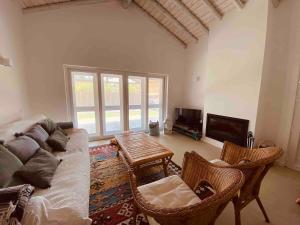a living room with a couch and a table at Pego Beach House in Grândola