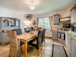 a kitchen with a wooden table and chairs at 2 Bed in Dunkineely oc-ii05062 in Dunkineely +15 photos
