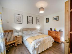 a bedroom with a bed and a wooden chair at 2 Bed in Dunkineely oc-ii05062 in Dunkineely
