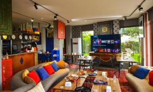 a living room with couches and a table and chairs at 10inn Boutique Hotel in Batumi