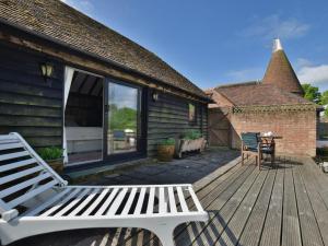 a white bench sitting on a wooden deck at 1 Bed in Ashford oc-bt064 in Biddenden