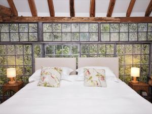a bedroom with a white bed with windows at 1 Bed in Ashford oc-bt064 in Biddenden