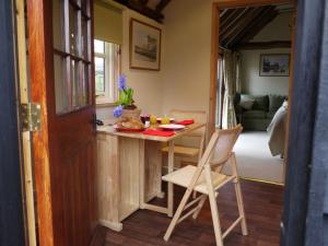 a kitchen with a table and chairs in a room at 1 Bed in Ashford oc-bt064 in Biddenden