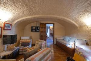 a living room with a couch and chairs at Pla de Moixons in Oristá