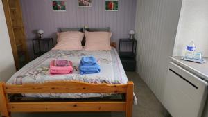 a bedroom with a bed with two towels on it at Chambre d'Hôtes le Gachignard in Courlay