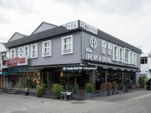a black building with a sign on the front of it at HP Hope Hotel in Johor Bahru