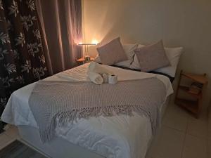 a bedroom with a bed with two towels on it at Sandstone Unit Brenthill Condo in Baguio